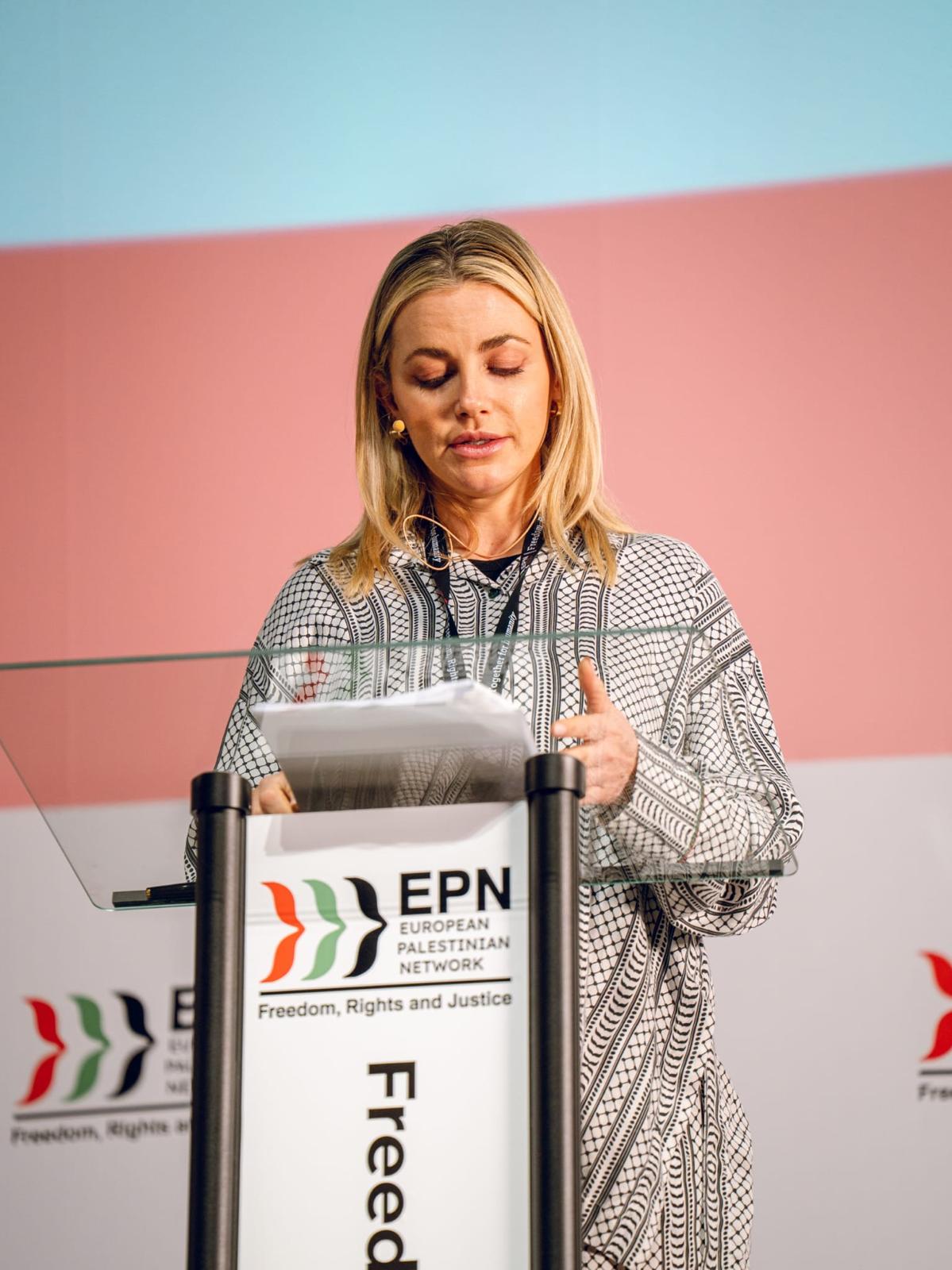 Speaker at the EPN lectern bearing the words “Rights and Justice”.